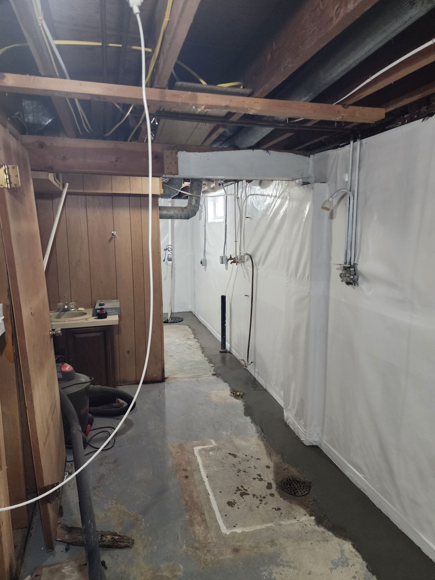 Vapor barrier installed around wood paneling and utility connections — Beaverdale, Des Moines, IA