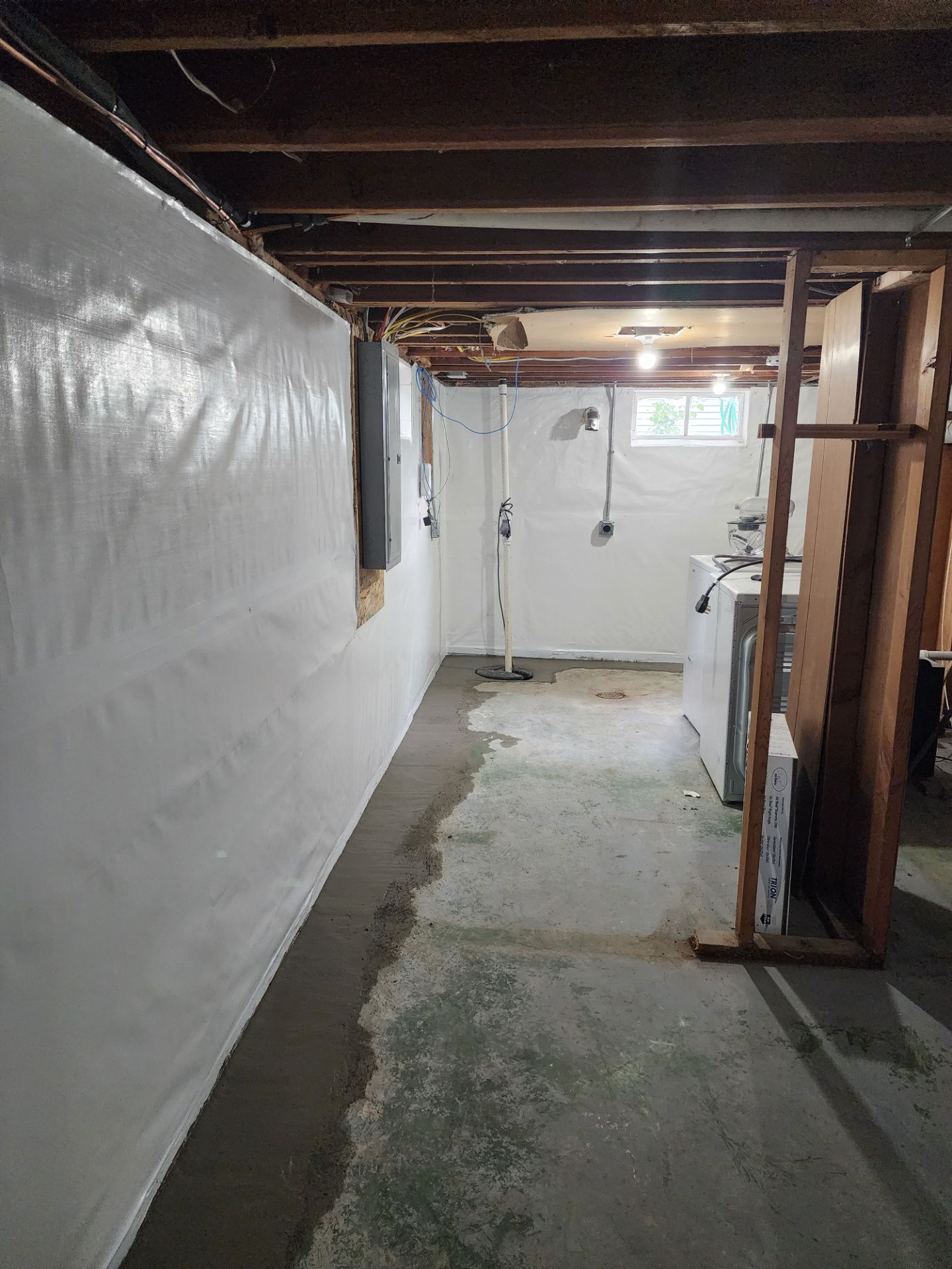 Completed waterproofing system from reverse angle showing full coverage — Beaverdale, Des Moines, IA