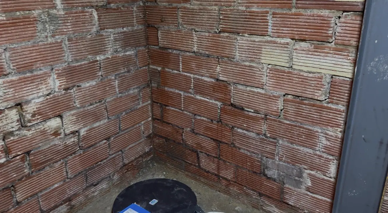 Damp basement block wall showing moisture stains before waterproofing — Liberty, MO