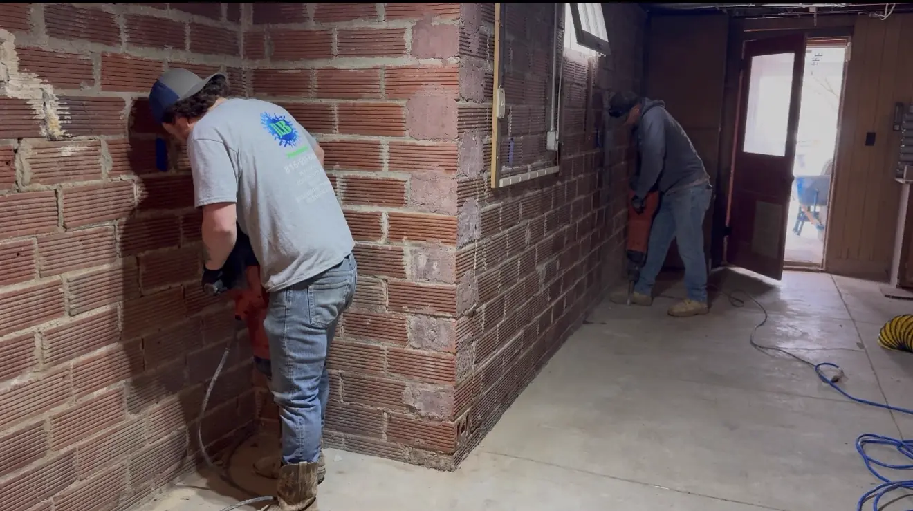 Crew jackhammering perimeter trench along basement wall — Liberty, MO