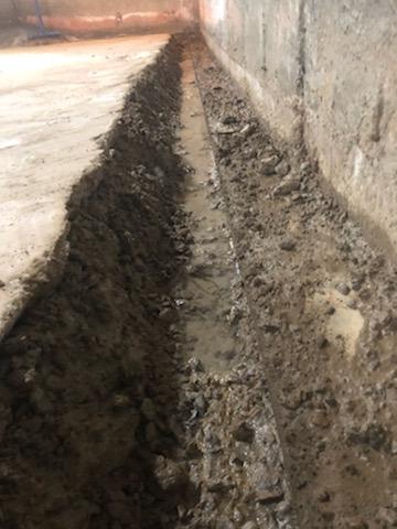 Perimeter drain tile trench excavated along basement wall — Overland Park, KS
