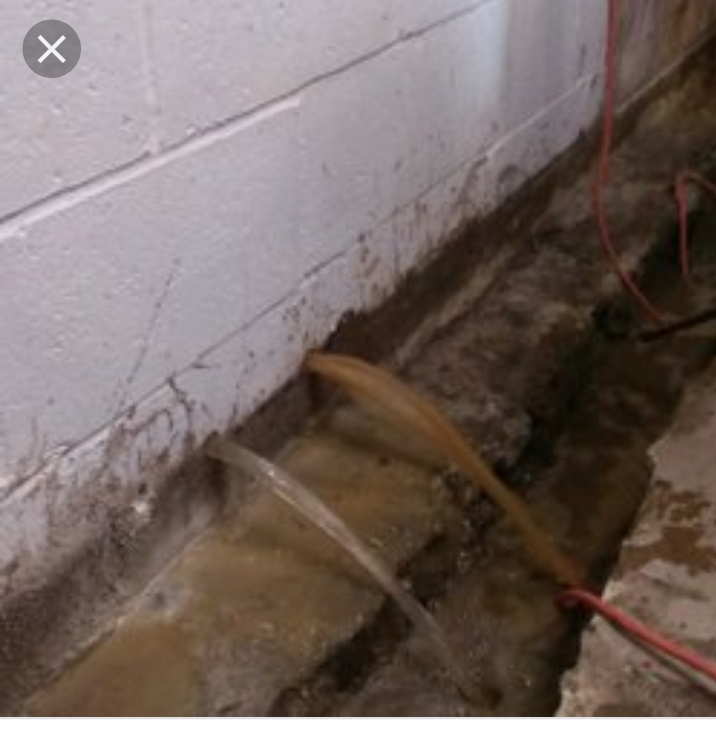 Drain tile pipe being installed along block wall footing — Overland Park, KS