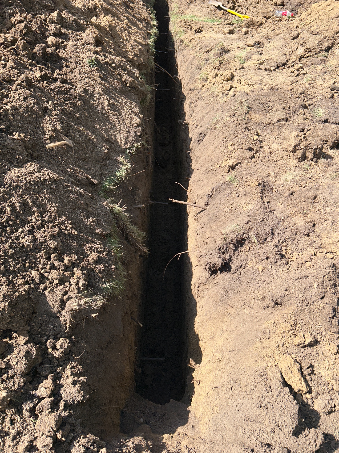 Trench excavation through clay soil for drain line — Shawnee, KS