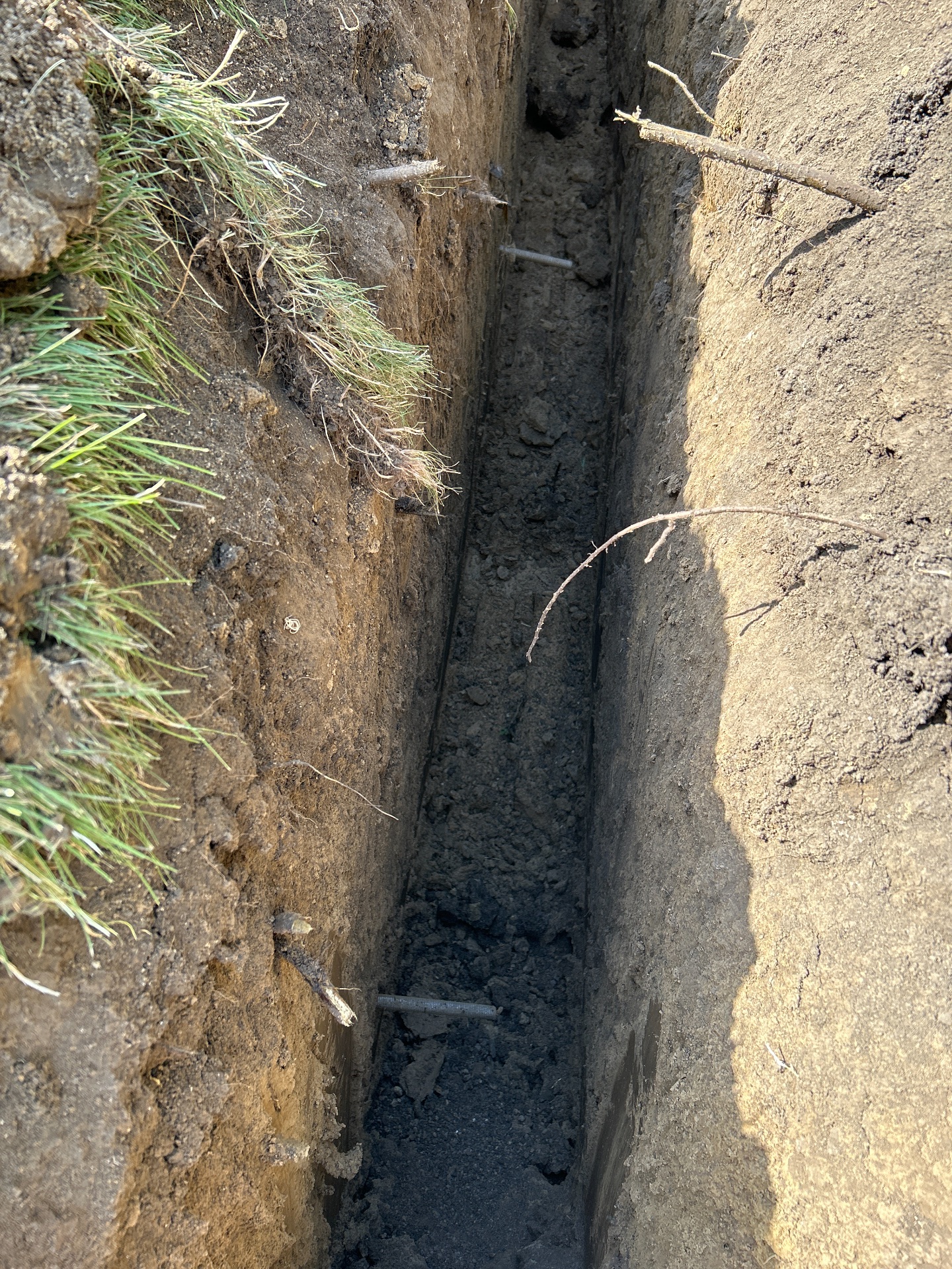 Drain line trench showing dense Johnson County clay — Shawnee, KS