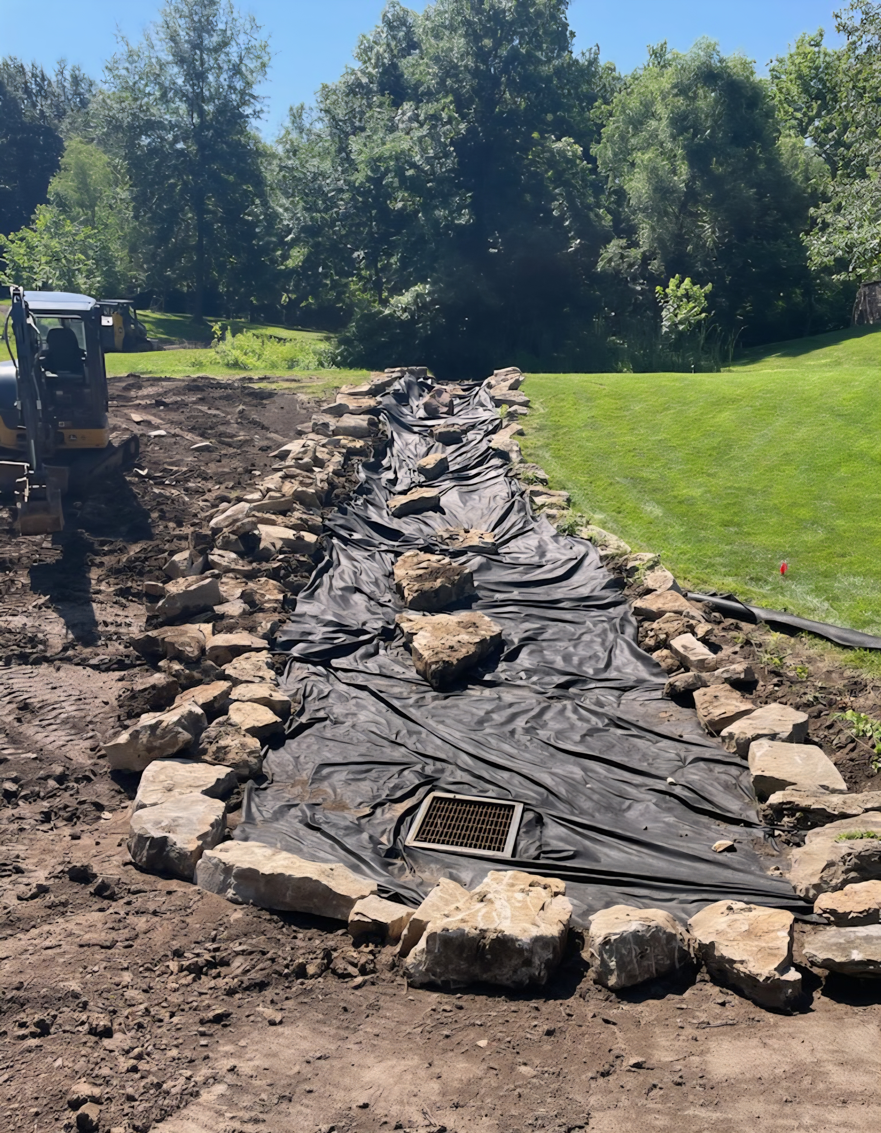 Rock-lined drainage swale with fabric and catch basin — Shawnee, KS