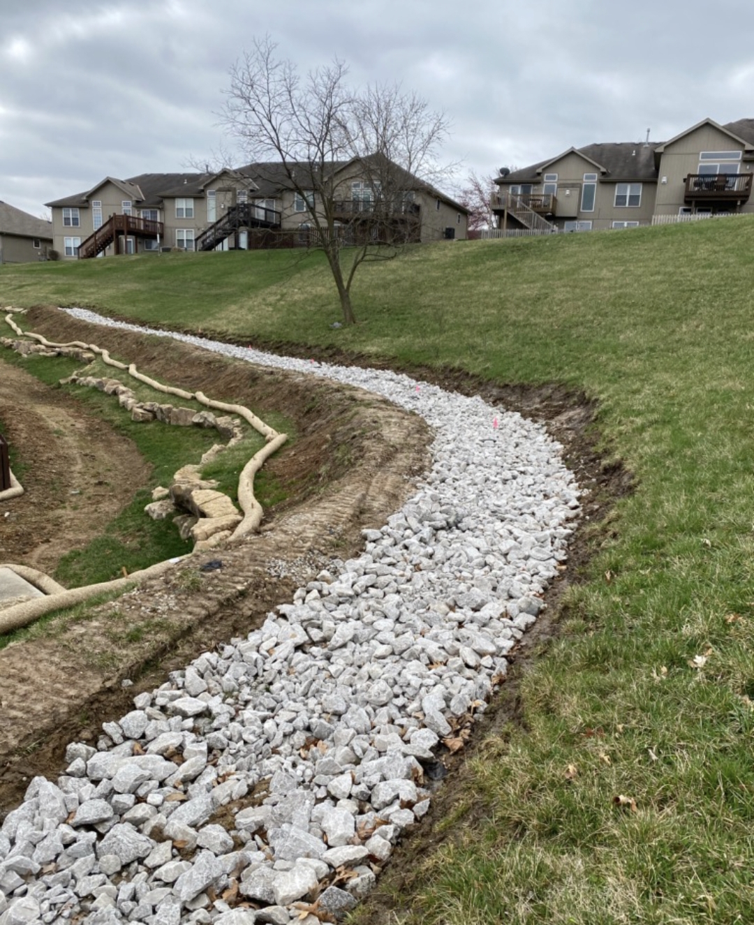 Final rock drainage channel result with landscaping — Lee's Summit, MO