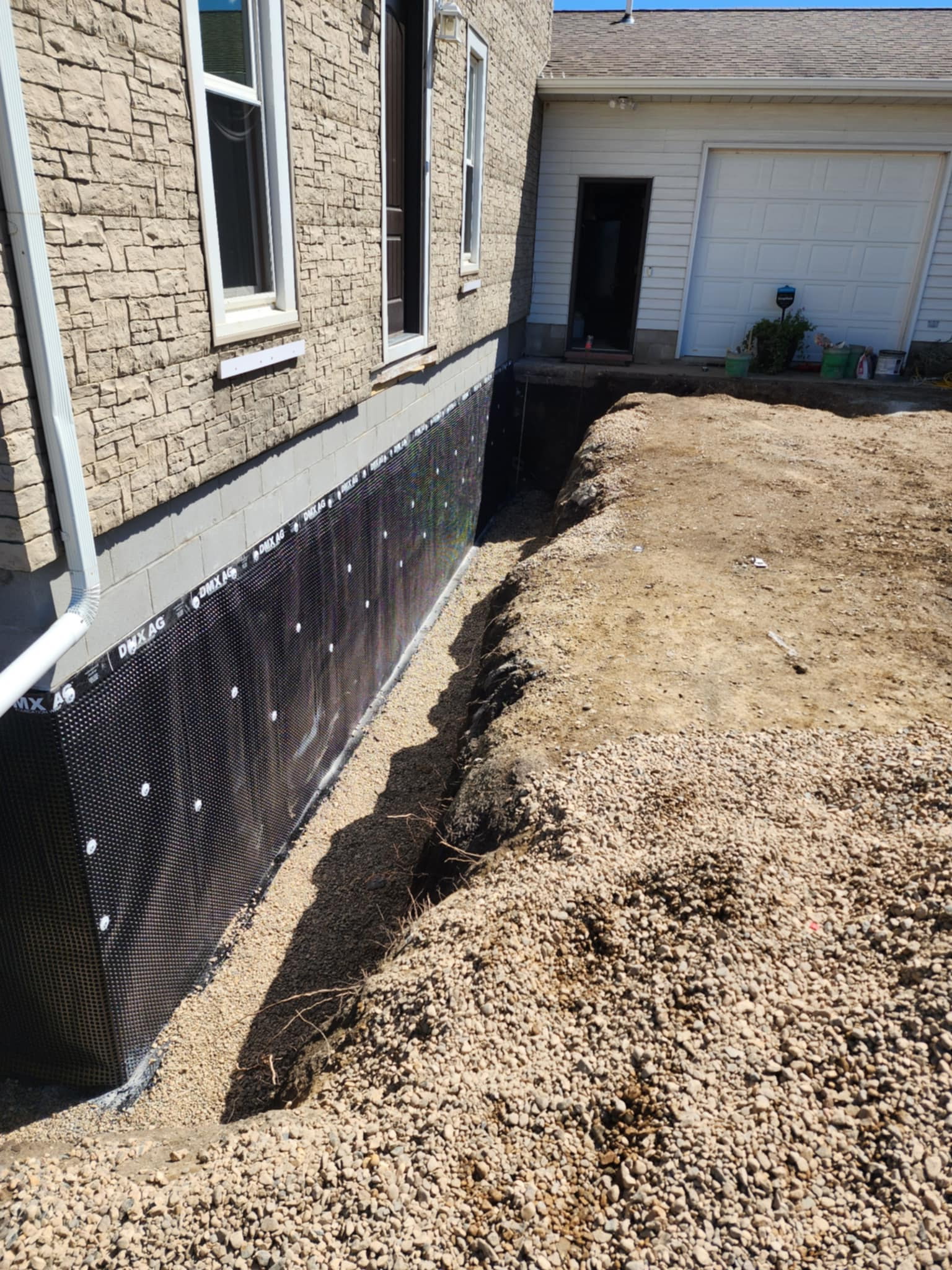 Dimple board waterproofing membrane installed on exterior foundation wall — Olathe, KS