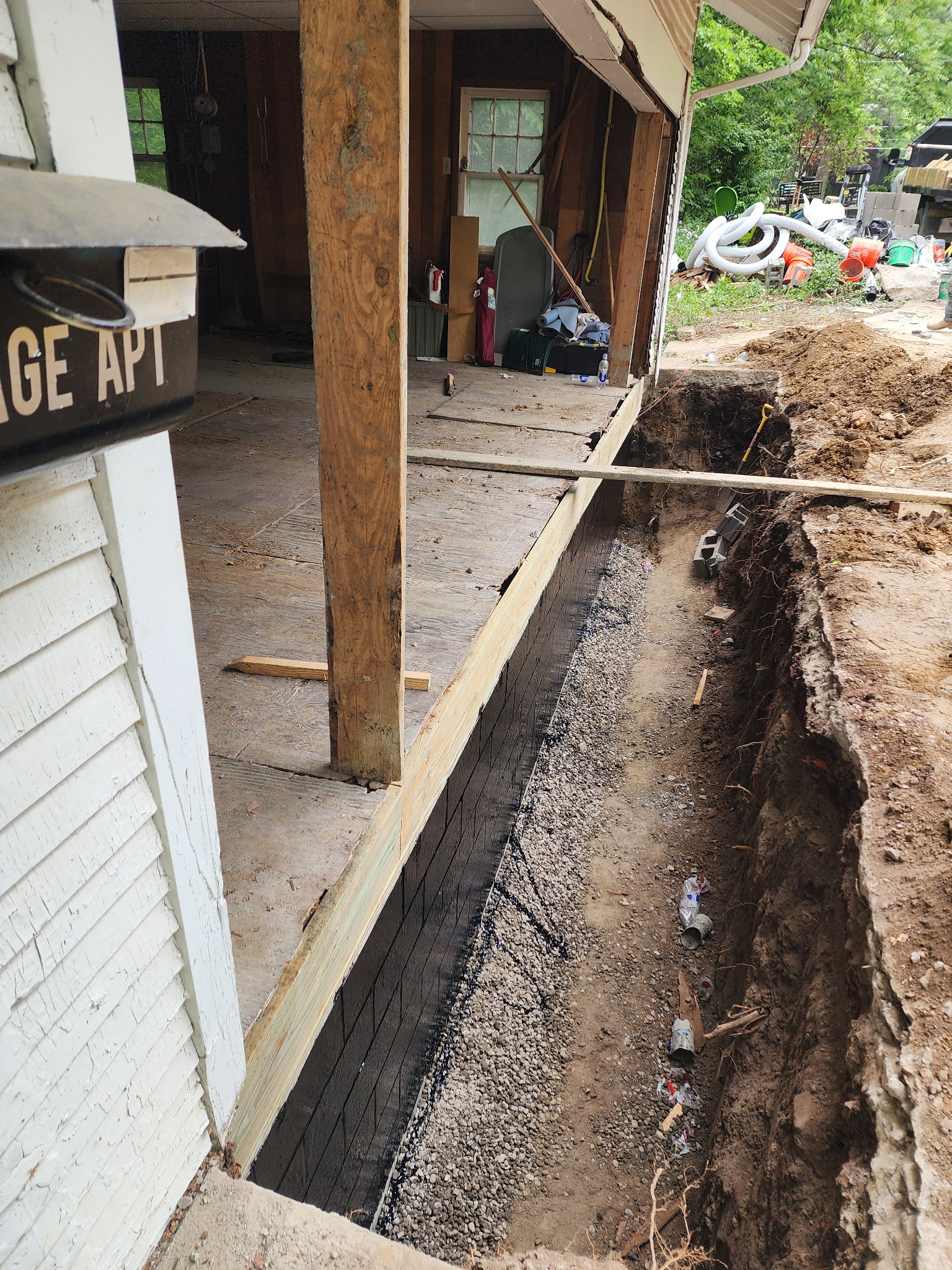 Foundation excavation with drain tile and gravel exposed at footing — Raytown, MO