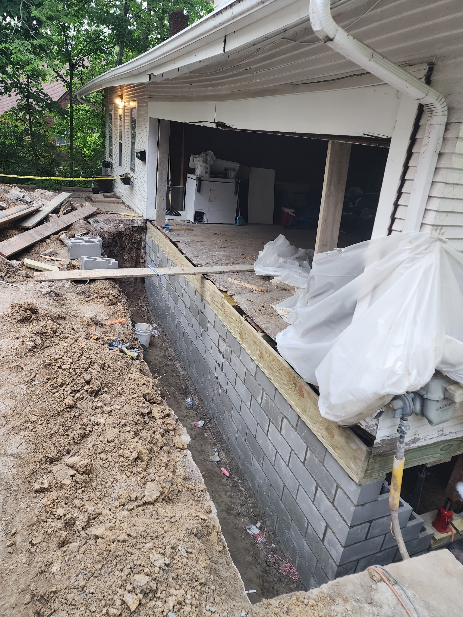 Block wall rebuild in progress with exterior excavation — Raytown, MO