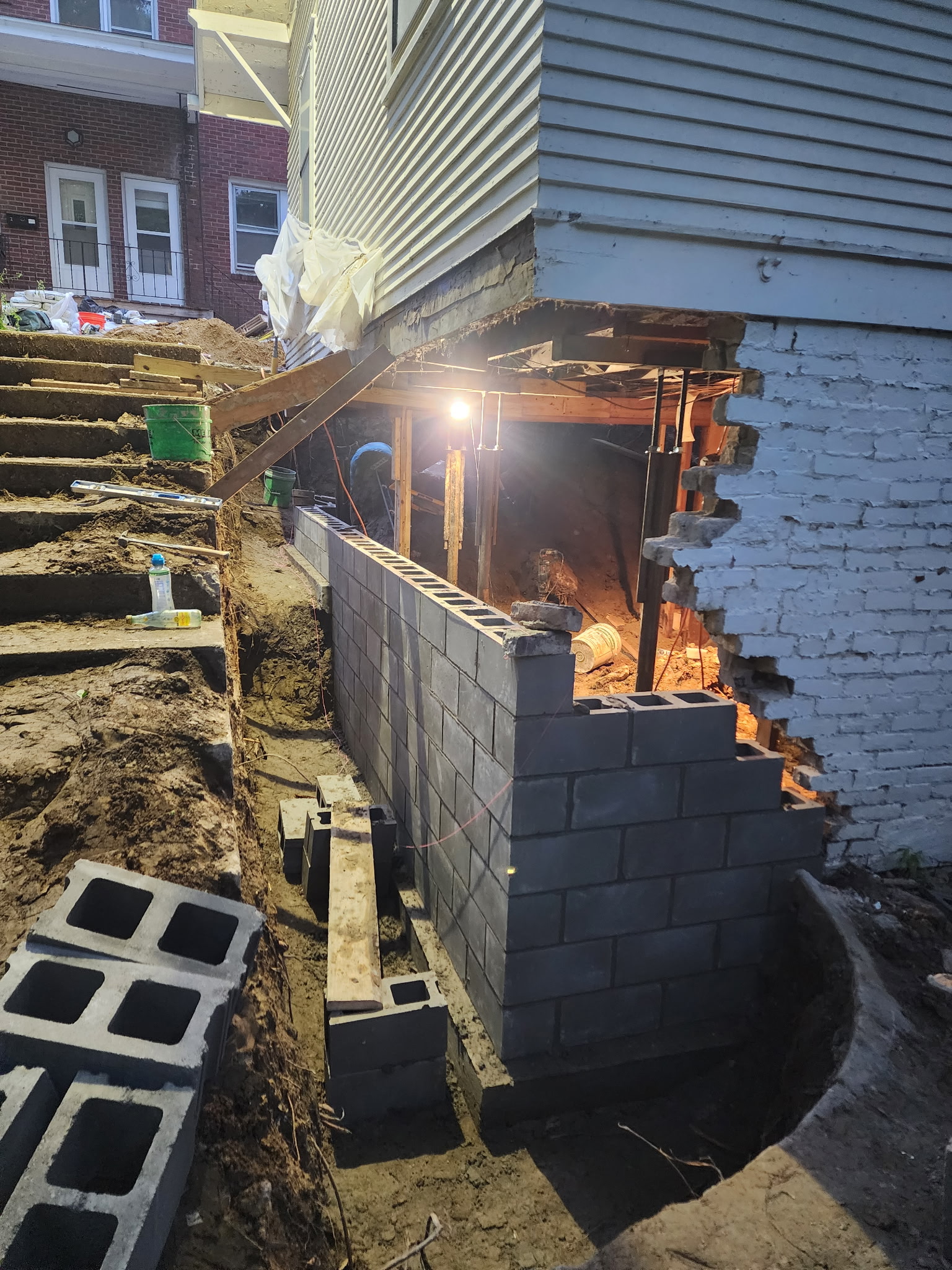Corner section block wall construction at night — Raytown, MO