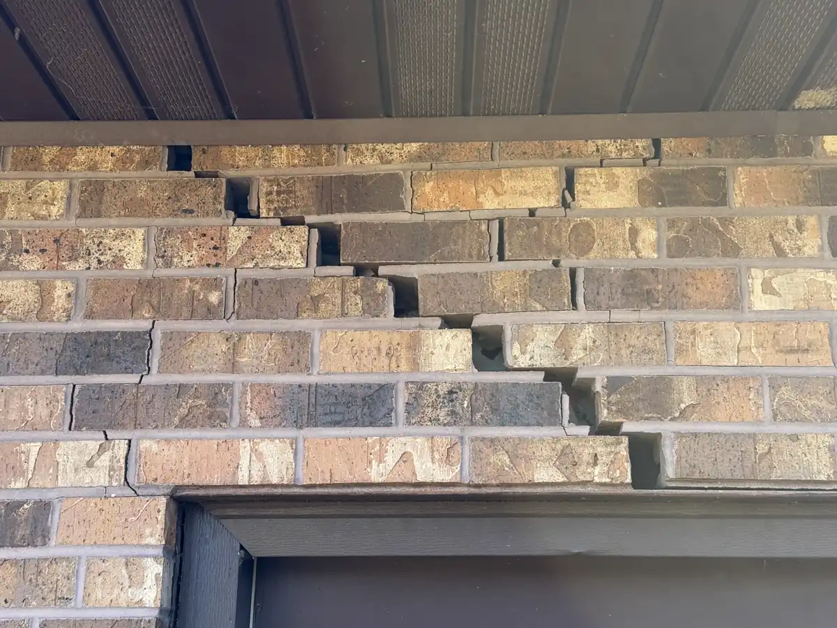 Foundation settling visible at rear garage wall before pier installation — Grandview, Missouri