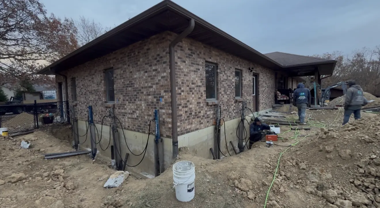 Steel pier brackets mounted along side foundation wall — Grandview, MO