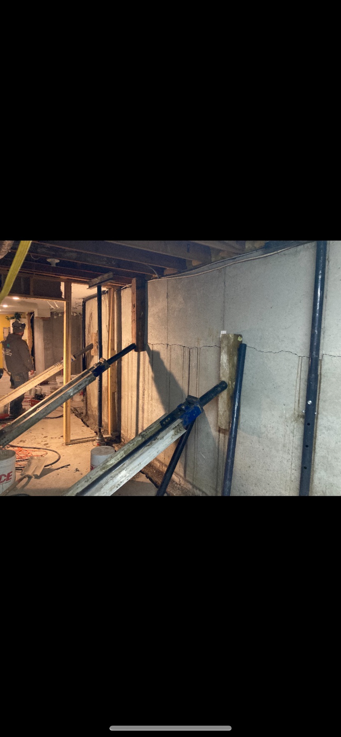 Steel wall brace installed against concrete block basement wall — West Des Moines, IA