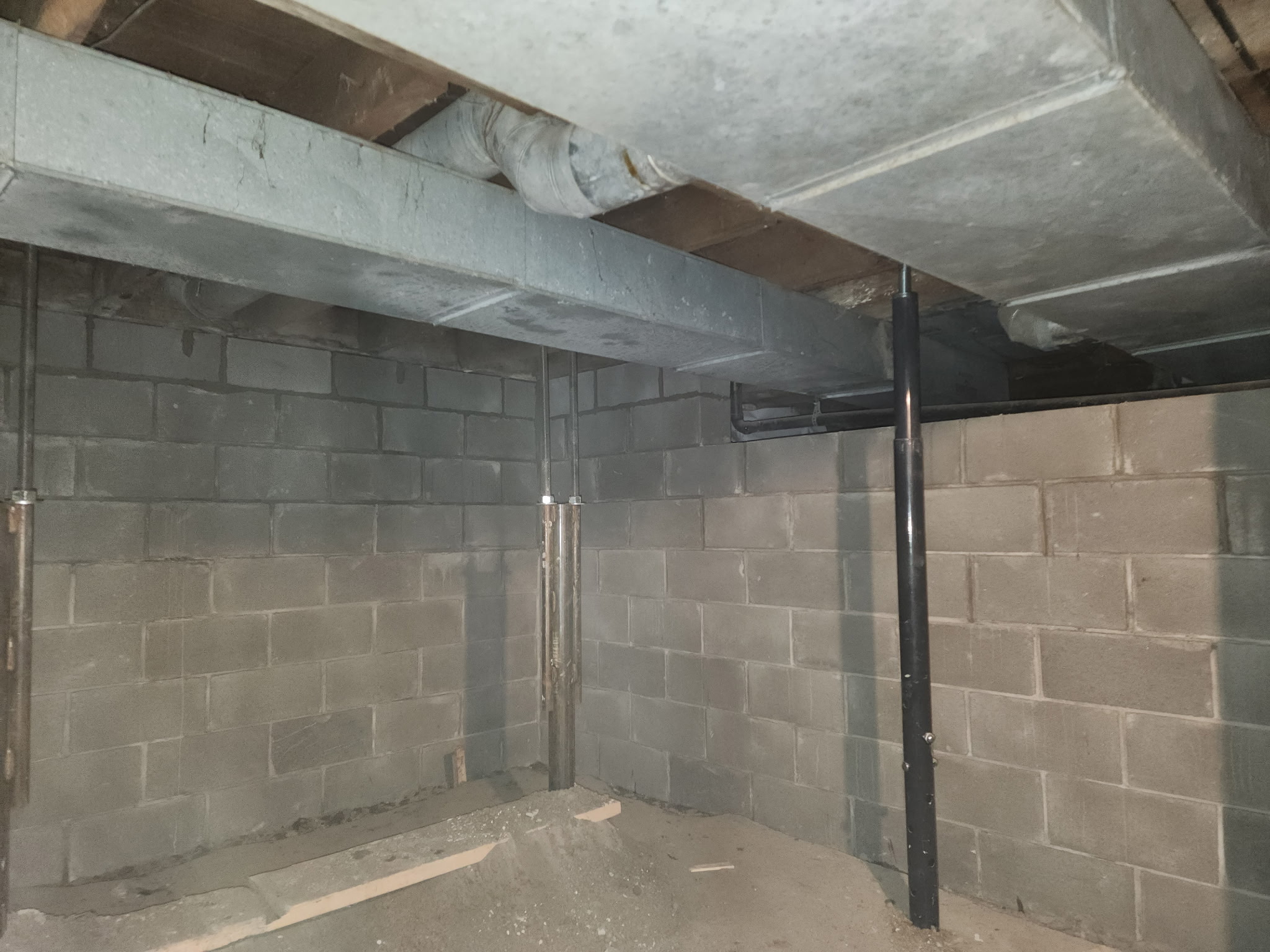Stabilized block wall basement after brace installation — West Des Moines, IA