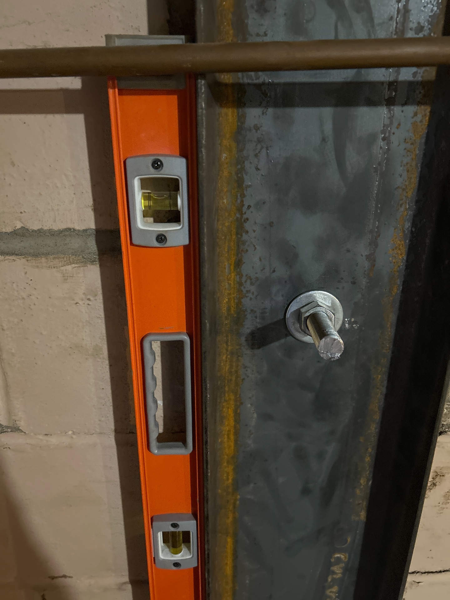 Level check confirming steel I-beam is plumb after installation — Independence, MO