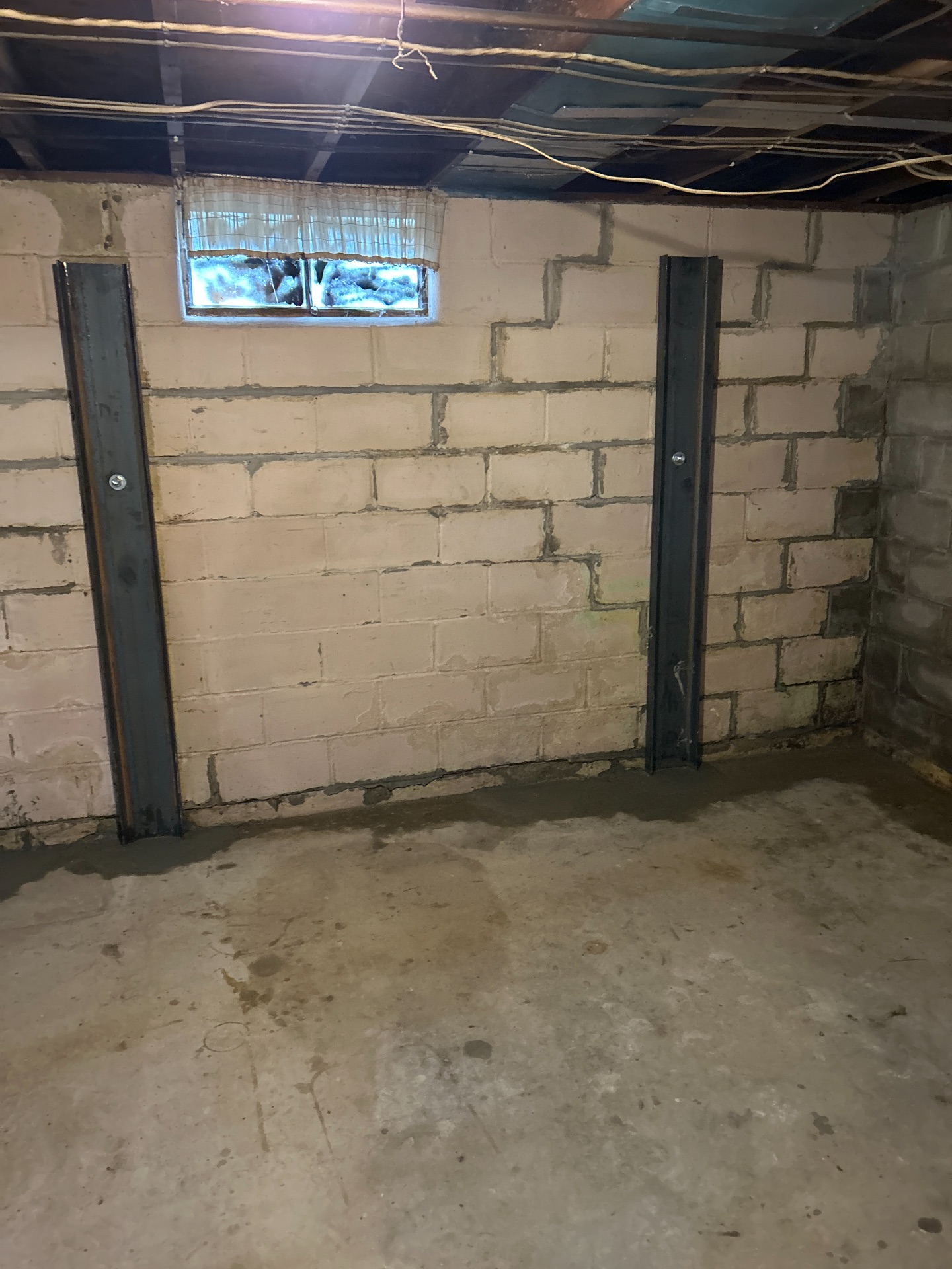 Steel I-beam wall braces installed on block wall — Independence, MO