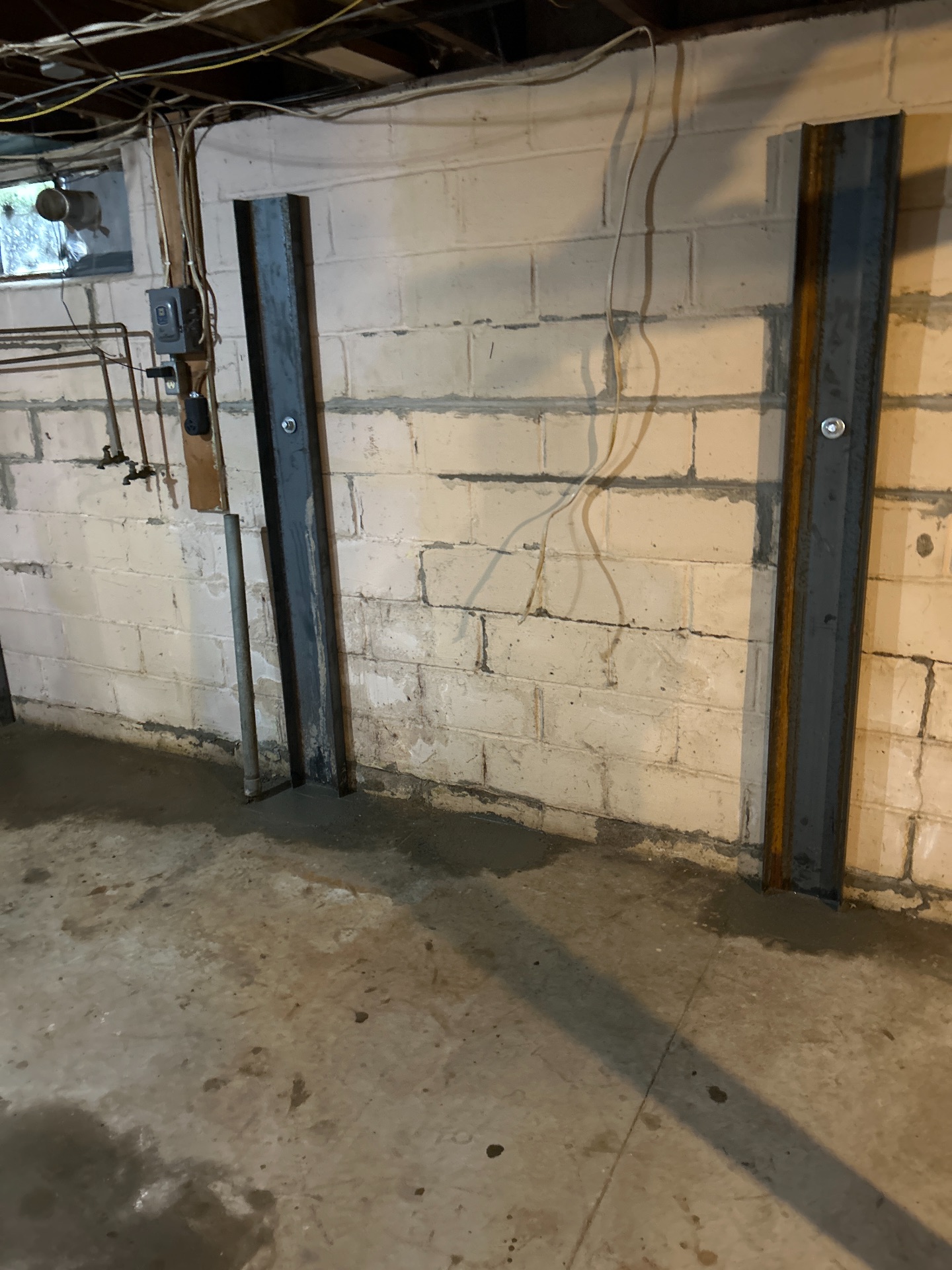 Multiple I-beam braces securing wall with copper plumbing — Independence, MO