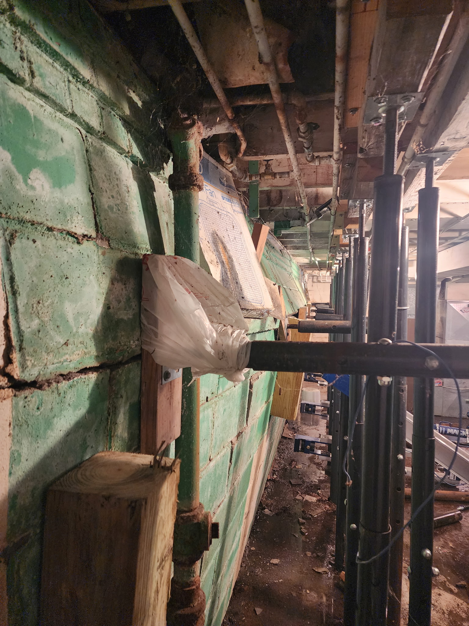 Severely bowing block wall with stair-step cracking and mortar deterioration — Westport, Kansas City, MO