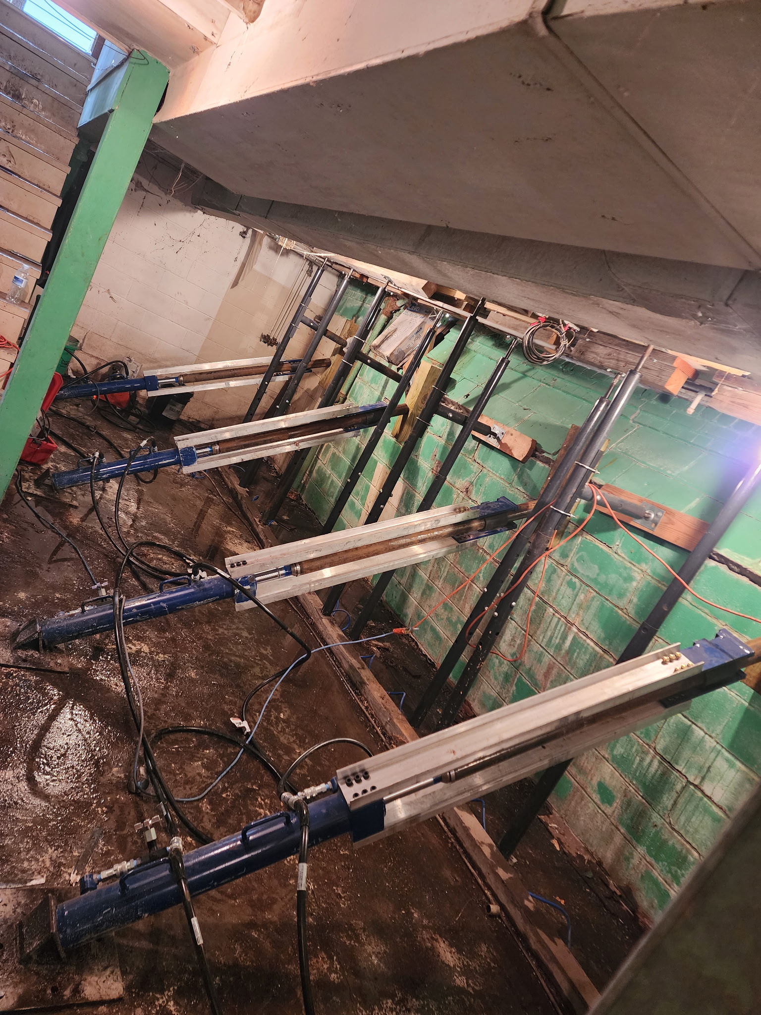 Hydraulic presses being used to straighten bowing wall — Westport, Kansas City, MO
