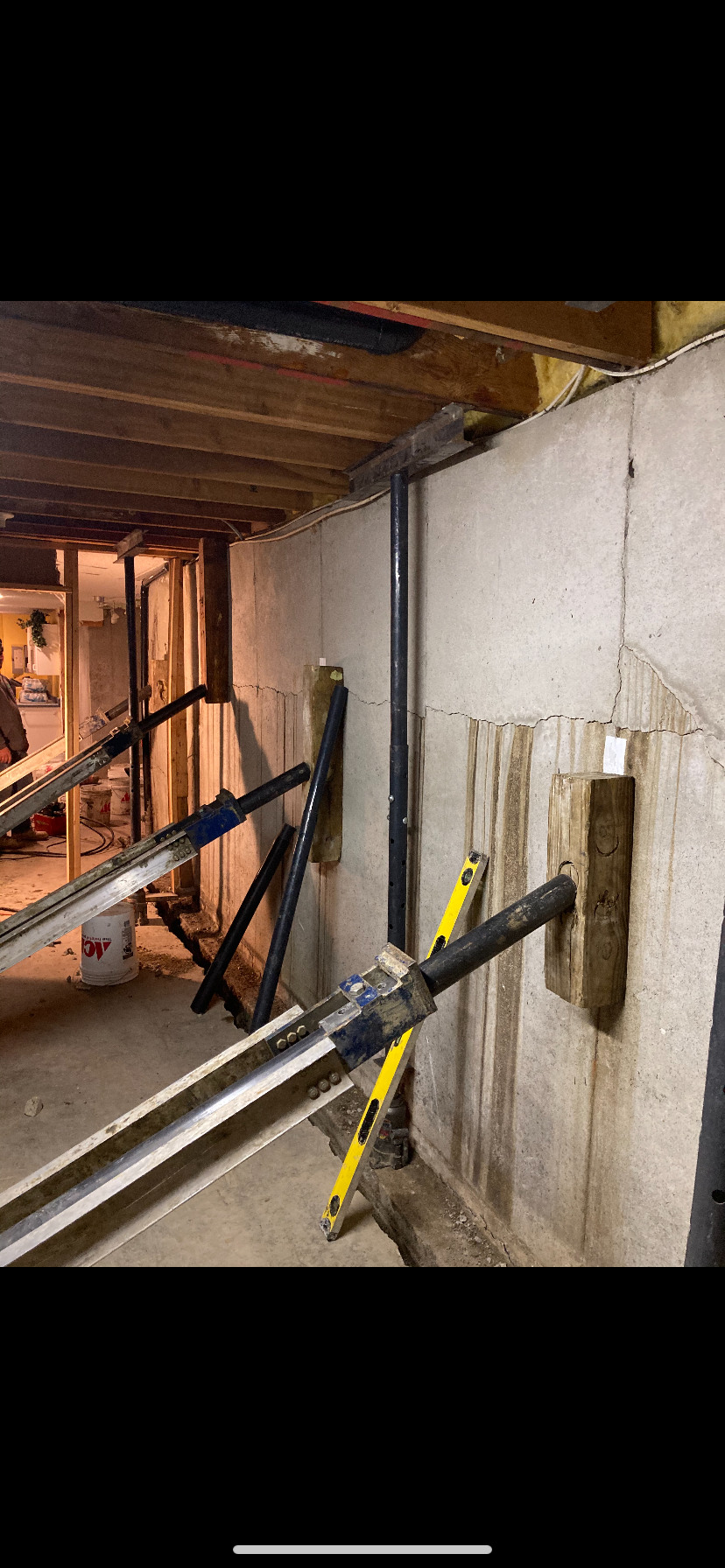 Completed wall bracing system stabilizing foundation wall — Westport, Kansas City, MO