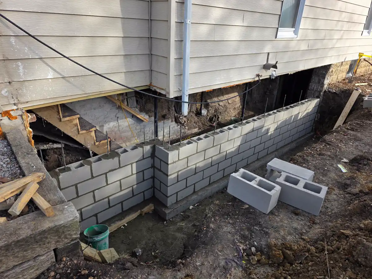 Old foundation wall section being removed with excavator — Kearney, Missouri