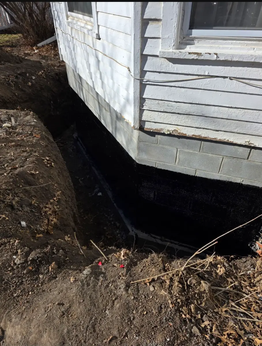 Excavation trench alongside damaged foundation wall — West Des Moines, IA
