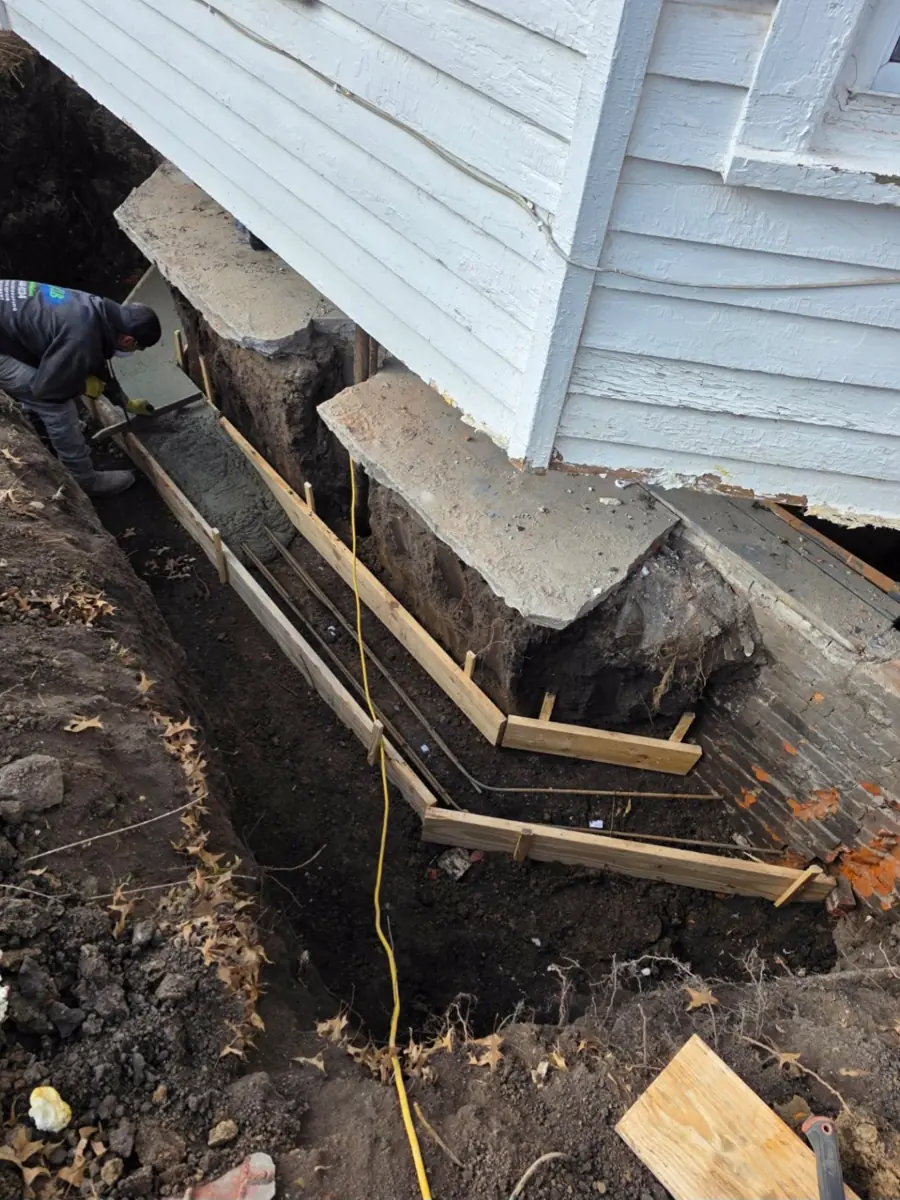 Rebar grid with fresh concrete being poured — West Des Moines, IA