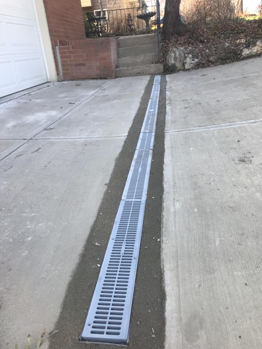 Channel drain installed across driveway apron — Urbandale, IA