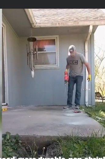 Inspecting sunken front porch slab before polyjacking — Gladstone, MO