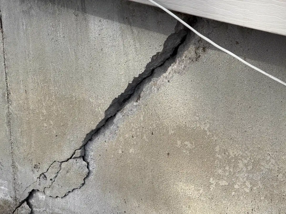 Steel wall anchor plate bolted to basement wall — Lee's Summit, MO