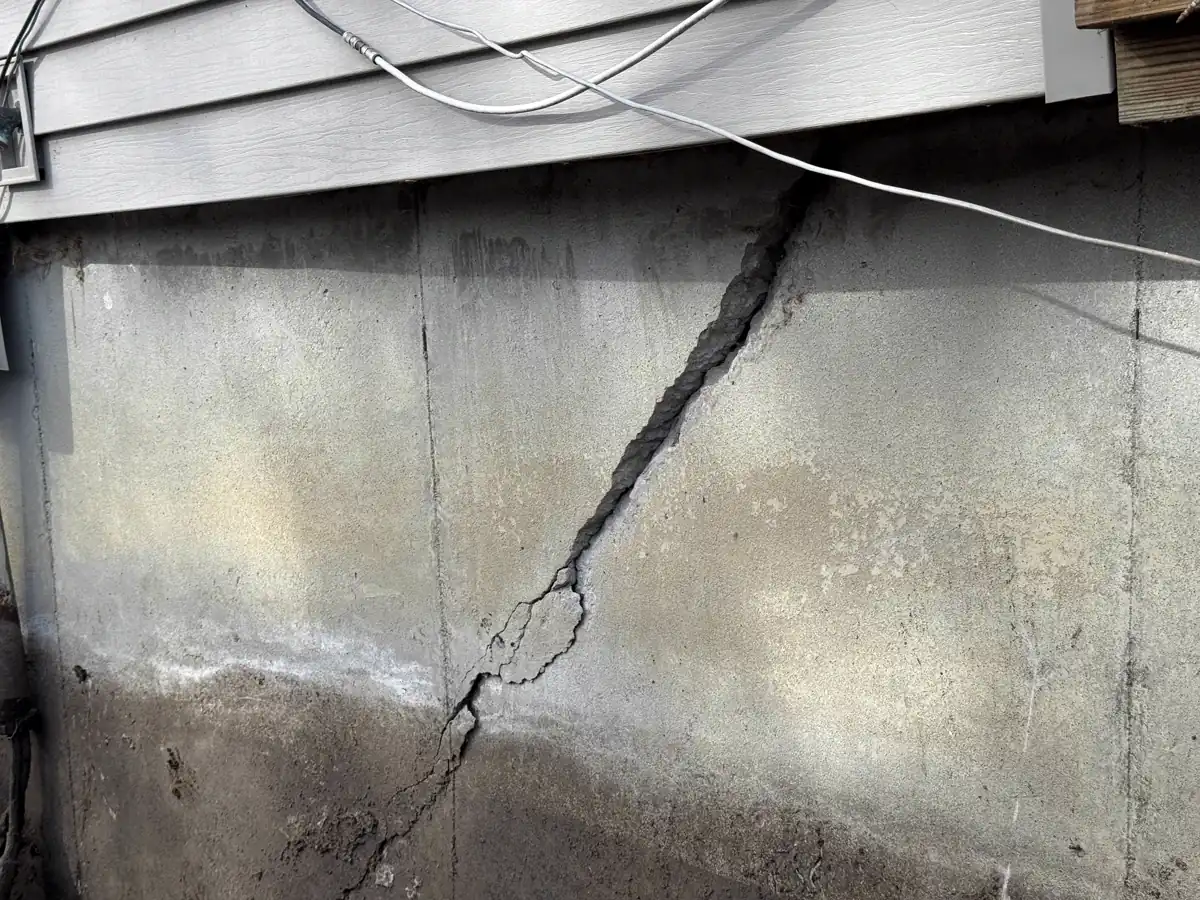Anchor rod extending through foundation wall to earth plate — Lee's Summit, Missouri