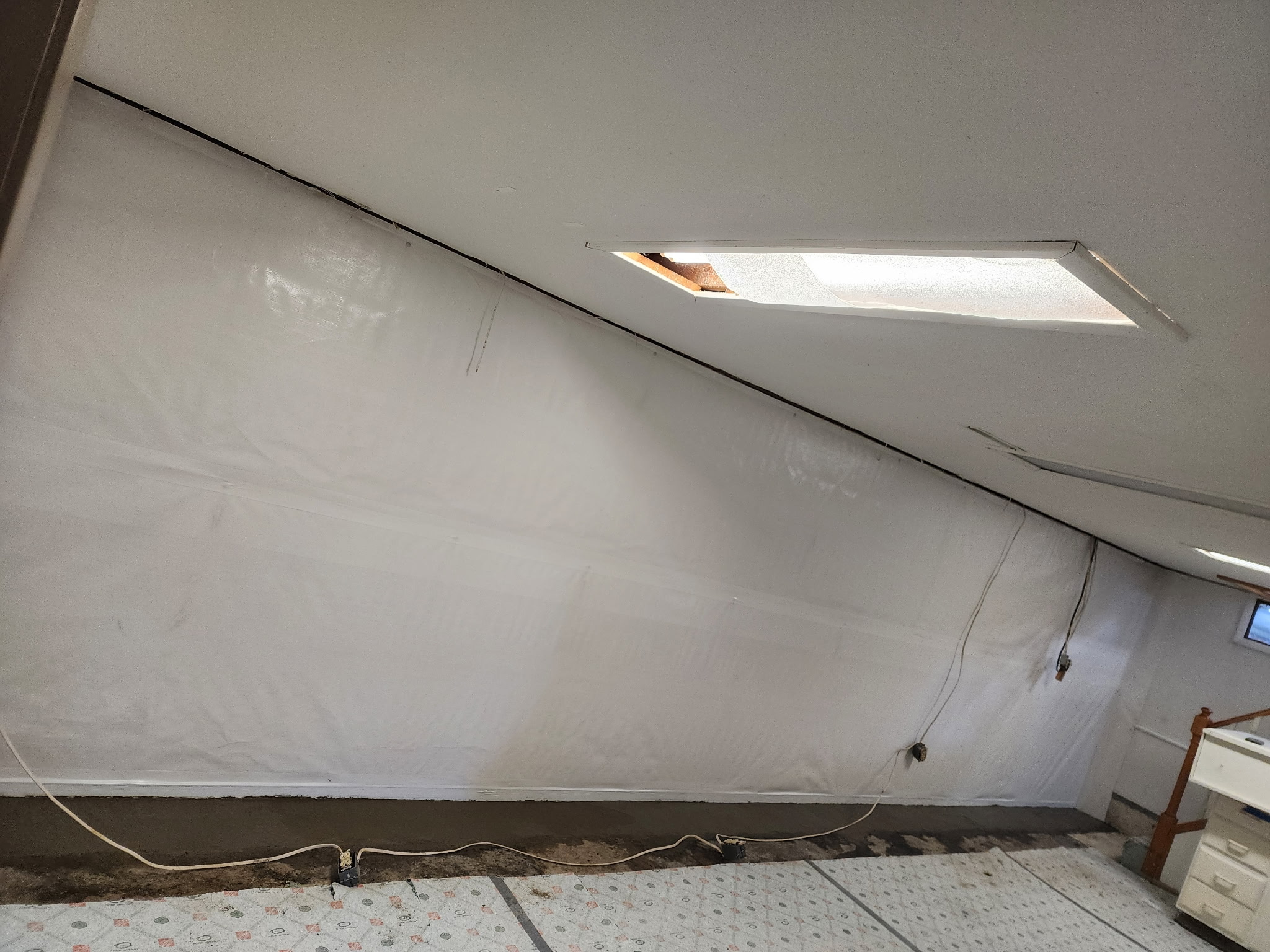 Vapor barrier covering sloped wall section in basement — Blue Springs, MO