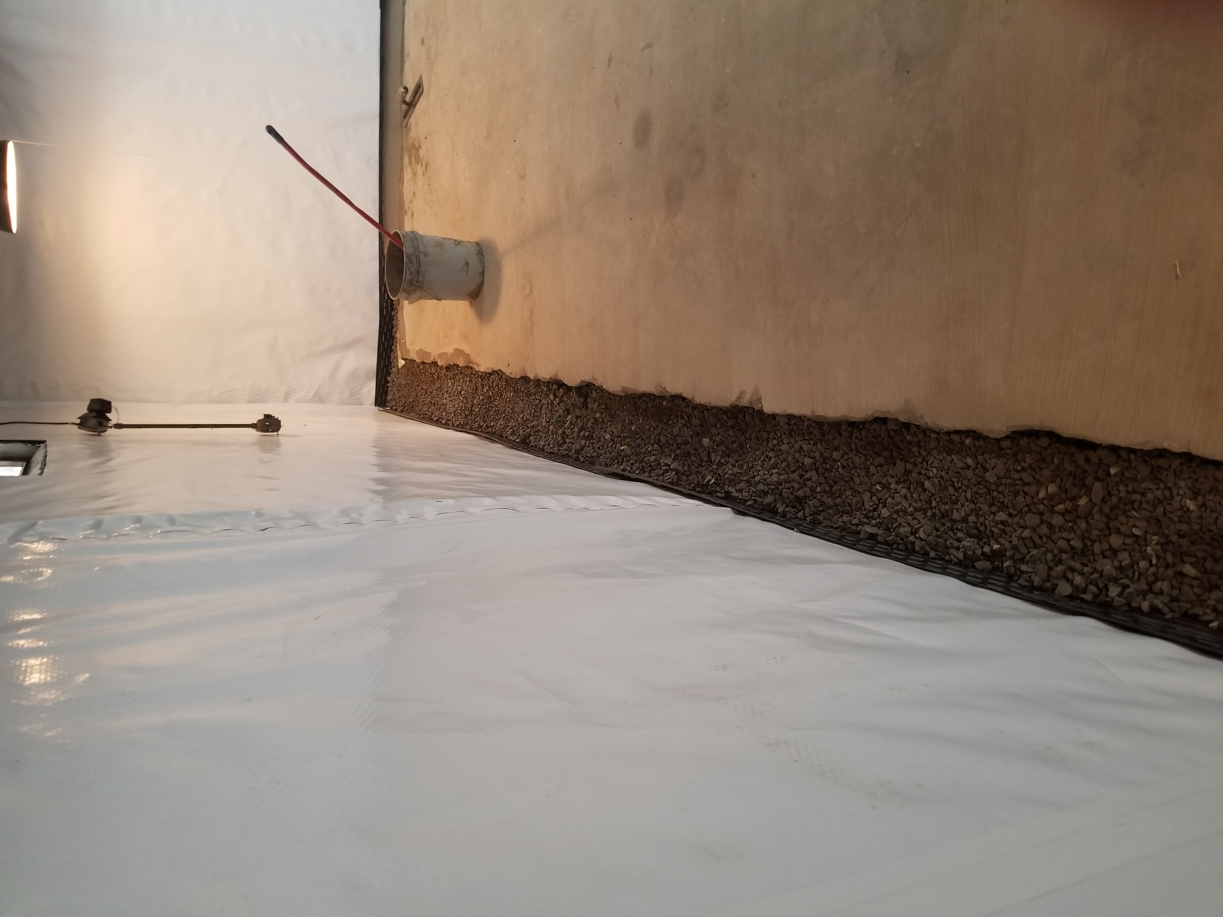 Floor liner over gravel drain tile system during installation — Blue Springs, MO