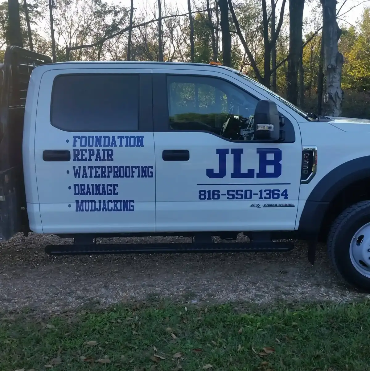 Front angled view of JLB company truck serving Van Meter and Dallas County