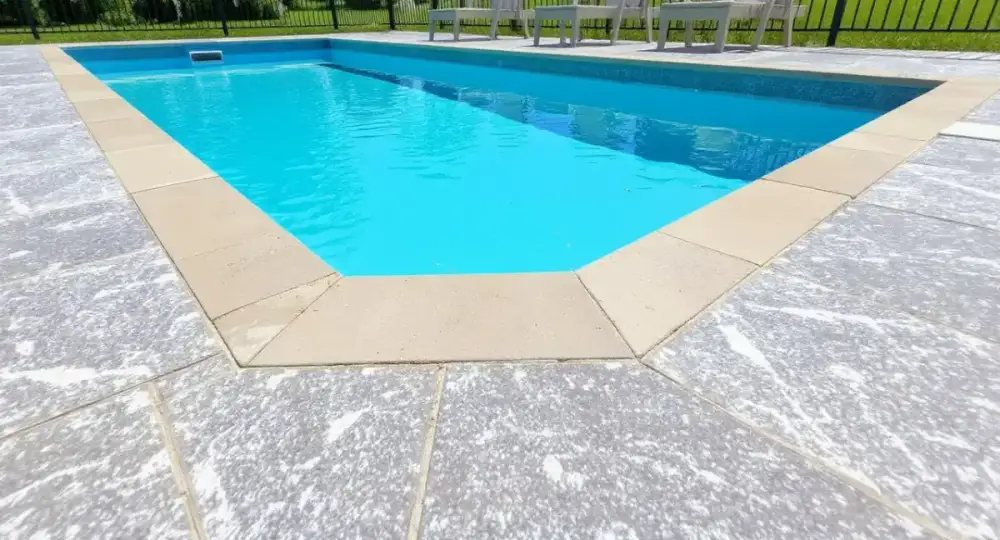 Slip-textured concrete pool deck at the coping — pool decks by JLB in Ames, Iowa