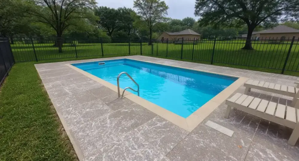 Concrete pool deck with steps and handrail — pool decks by JLB in Ames, Iowa