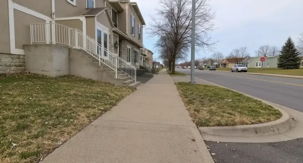 Public concrete sidewalk with an ADA curb ramp — sidewalks by JLB in Clive, Iowa