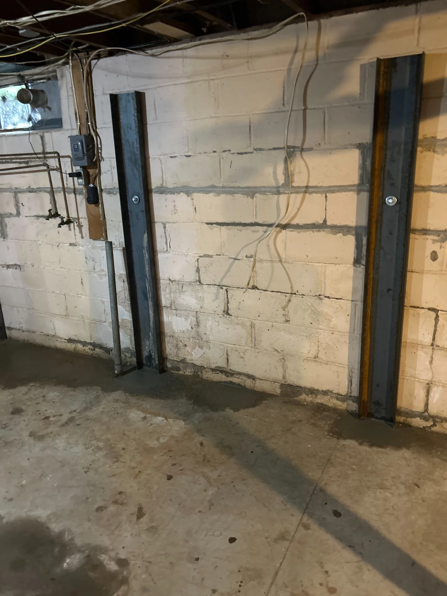 Wall braces securing multiple wall sections