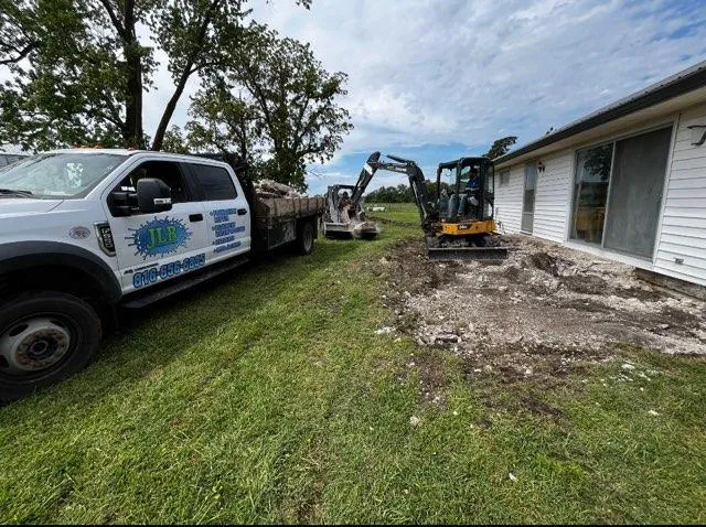 JLB truck and crew excavating at a foundation job in Van Meter, IA