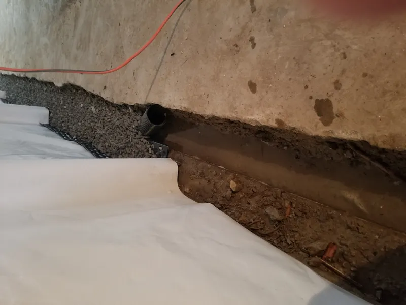 Drain tile pipe and gravel bed in a basement waterproofing system in Leavenworth, KS