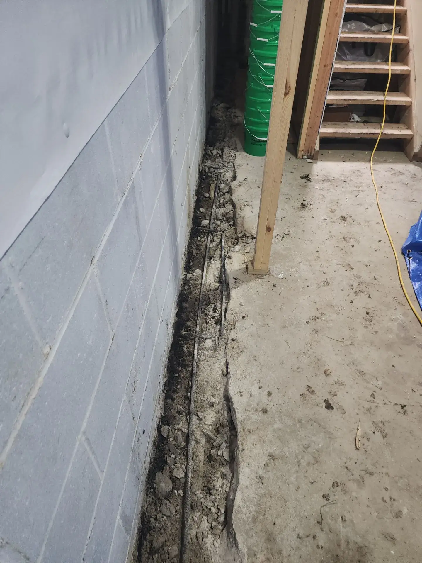 Drain channel along block wall in basement